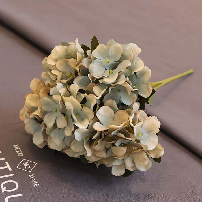 Artificial Hydrangea Floral Bunch arranged elegantly on a decorative surface, perfect for home and wedding décor.