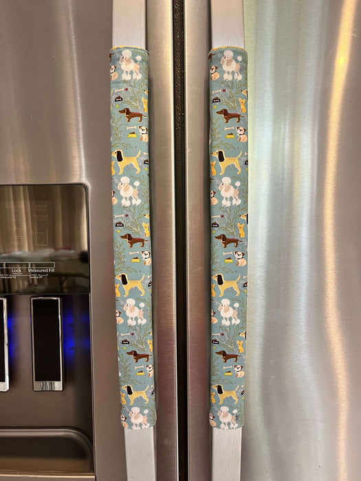 Cute puppy print appliance handle covers on refrigerator handles, enhancing kitchen decor and protecting from stains.