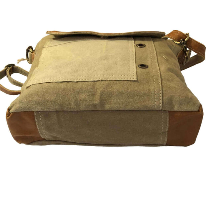 Eco-friendly khaki shoulder bag with tan leather flap, featuring sturdy canvas and adjustable strap.