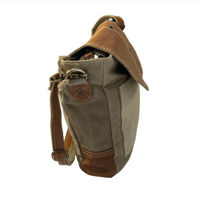 Eco-friendly khaki shoulder bag with tan leather flap side view showcasing adjustable strap and sturdy design.