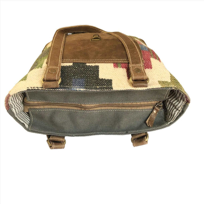 Multi color canvas tote bag with leather pocket, showcasing spacious interior and unique design.