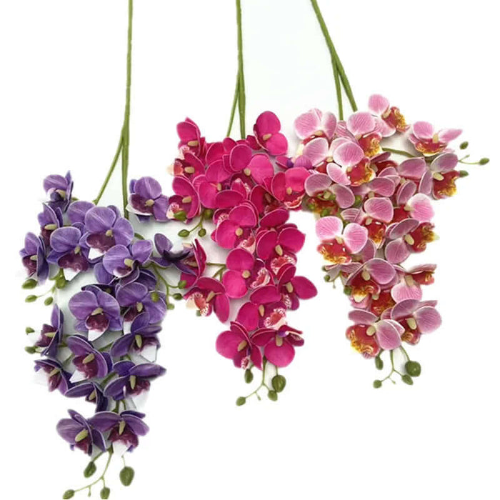 Colorful artificial phalaenopsis orchid stems in purple, pink, and fuchsia, showcasing realistic flower heads.
