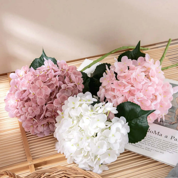Real touch latex hydrangea artificial flowers in pink and white with green leaves, perfect for elegant arrangements.