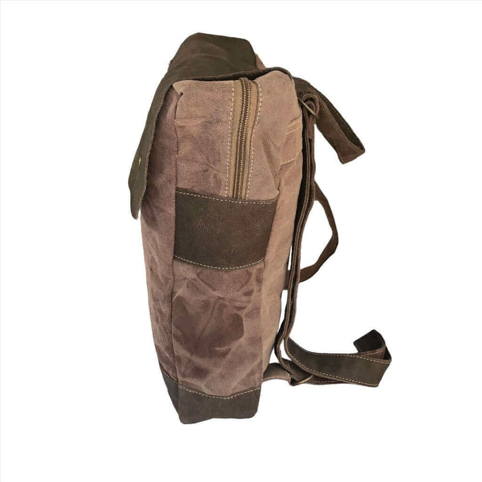 Side view of a stylish canvas and leather backpack featuring spacious compartments and minimalist design.