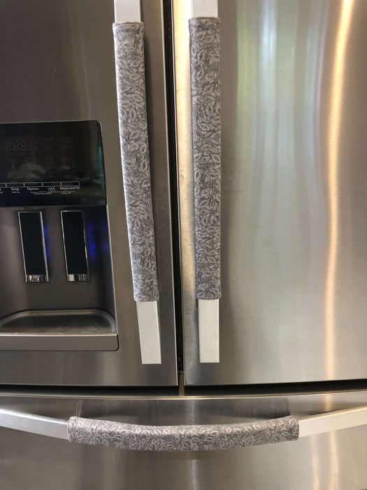 Grey Leaf Motif Appliance Handle Covers on stainless steel refrigerator, adding style and protection.