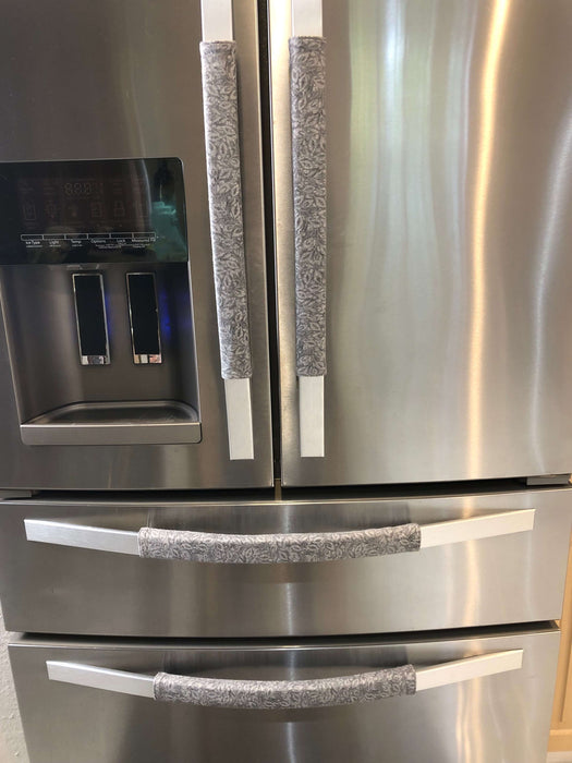 Grey Leaf Motif Appliance Handle Covers on stainless steel refrigerator handles for added style and cleanliness.