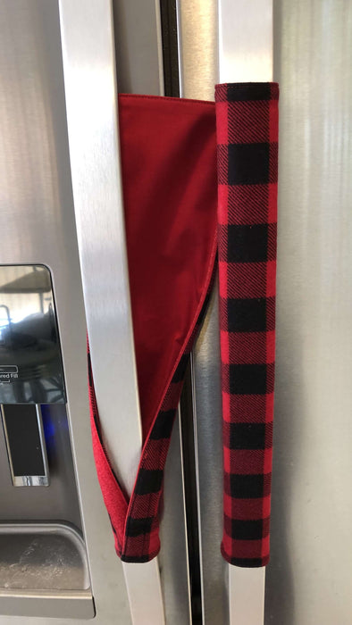 Red and black buffalo check appliance handle covers on refrigerator door, adding rustic charm and protecting handles.