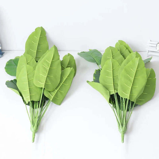 Real Touch Artificial Tropical Monstera Plant leaves in vibrant green, perfect for home or office decor.
