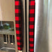 Red and black buffalo check appliance handle covers on refrigerator handles for a rustic kitchen look.
