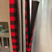 Red and black buffalo check appliance handle covers on stainless steel fridge, adding rustic charm and protection.
