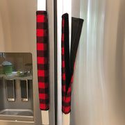 Red-and-black plaid appliance handle covers on a fridge door.