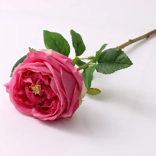 Real-touch artificial pink rose with green leaves and realistic details on a white background.