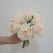 Artificial latex snow mountain rose bouquet held in hand, featuring realistic petals in soft pink and white hues.