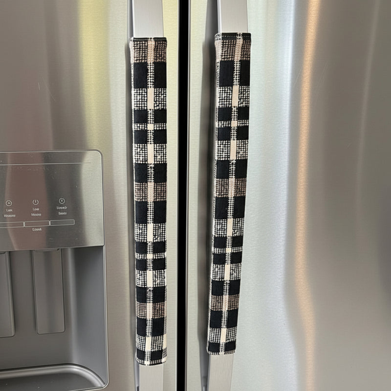 Black and cream checkered refrigerator handles on a stainless steel refrigerator.