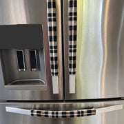 Stainless steel refrigerator with black and cream checkered handle covers