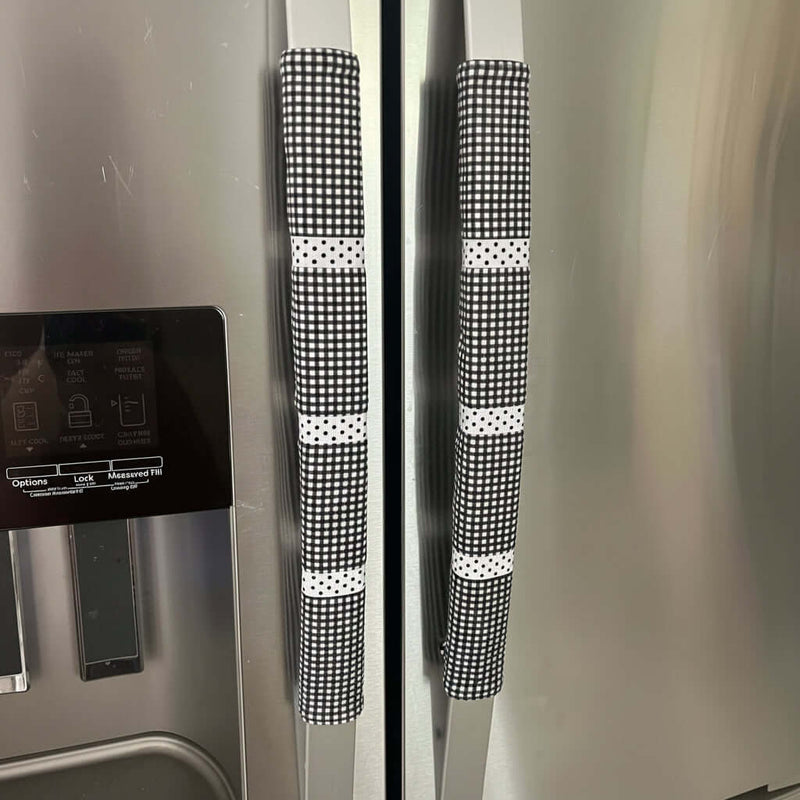 Black and white checkered handle covers on a stainless steel refrigerator.