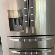 Stainless steel refrigerator with water and ice dispenser in a kitchen setting
