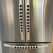 Stainless steel refrigerator with black and white checkered handle covers