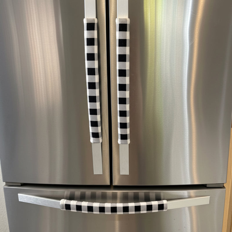 Stainless steel refrigerator with black and white checkered handle covers