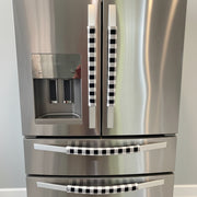 Stainless steel refrigerator with black and white checkered handle covers