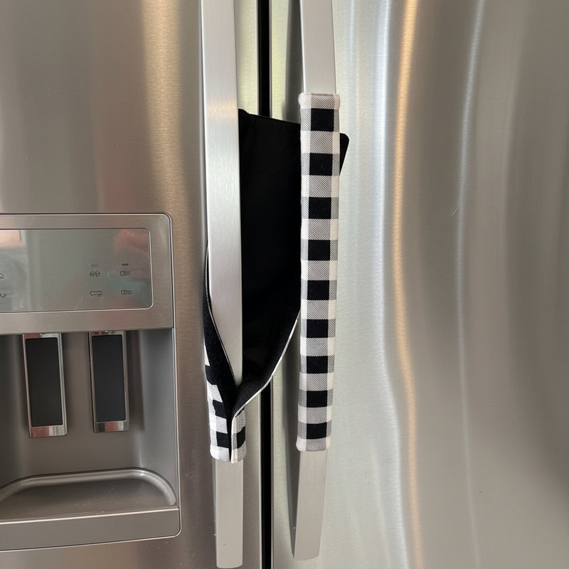 Black and white checkered handle cover draped over a refrigerator handle