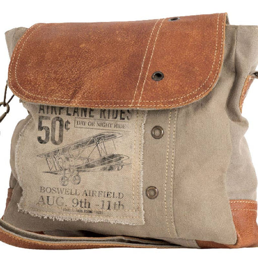 Canvas leather crossbody handbag featuring vintage airplane ride graphic and contrasting leather flap.