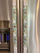 Cute puppy print appliance handle covers on refrigerator handles, enhancing kitchen decor and protecting from stains.