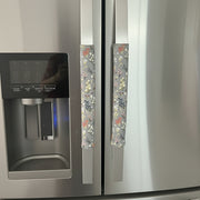 Floral-patterned handle covers on a stainless steel refrigerator.