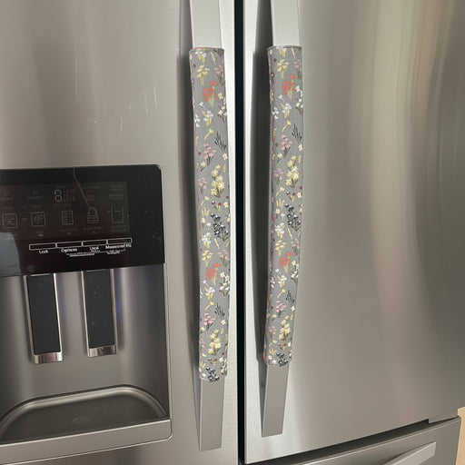 Stainless steel refrigerator with floral-patterned handle covers