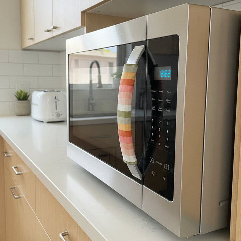Multicolored striped handle cover on a microwave door handle