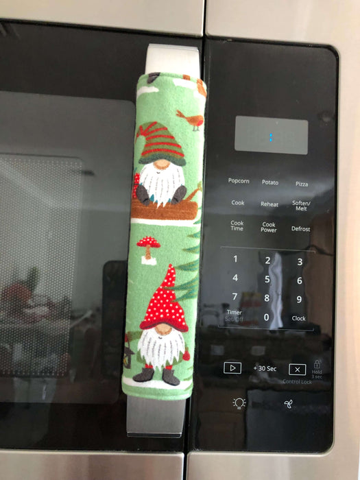 Gnomes on The Green Christmas Appliance Handle Covers on a refrigerator handle, festive kitchen decor for the holiday season.