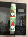 Gnomes on The Green Christmas Appliance Handle Covers on a refrigerator handle, festive kitchen decor for the holiday season.