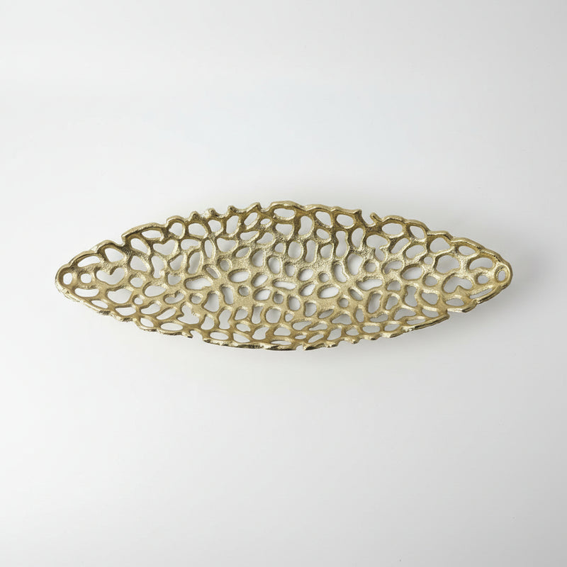 Decorative gold metal tray on a white surface