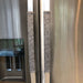 Grey leaf motif appliance handle covers on stainless steel refrigerator for protection and style.