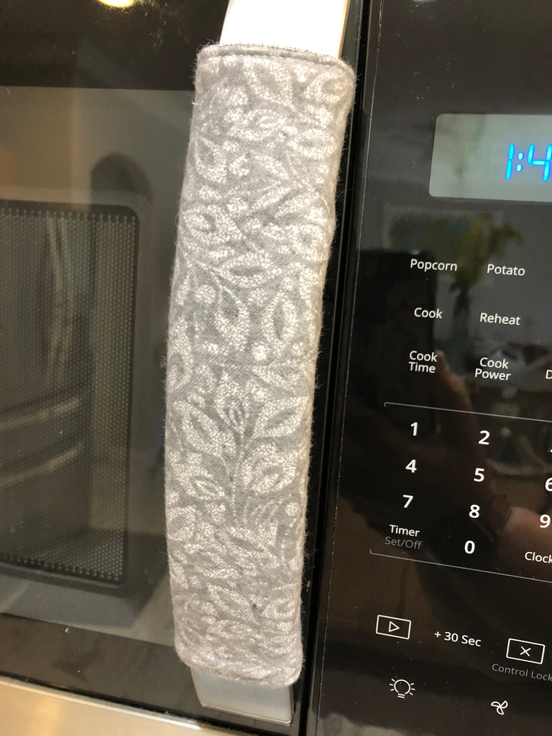Grey Leaf Motif Appliance Handle Covers displayed on a microwave for stylish kitchen decor.