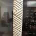 Grey geometric reversible handle cover on a refrigerator, adding style and protection to kitchen appliance.