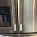 Grey leaf motif appliance handle covers on stainless steel refrigerator handles for added style and protection.