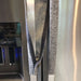 Grey leaf motif appliance handle cover on stainless steel refrigerator, showcasing its stylish design and easy application.