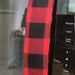 Red and black buffalo check appliance handle cover on a microwave, adding rustic charm and protection.