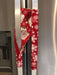 Festive red appliance handle cover with snowflakes and Santa design on a stainless steel fridge.