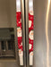 Festive red appliance handle covers with Santa and snowflakes, perfect for holiday kitchen decor.