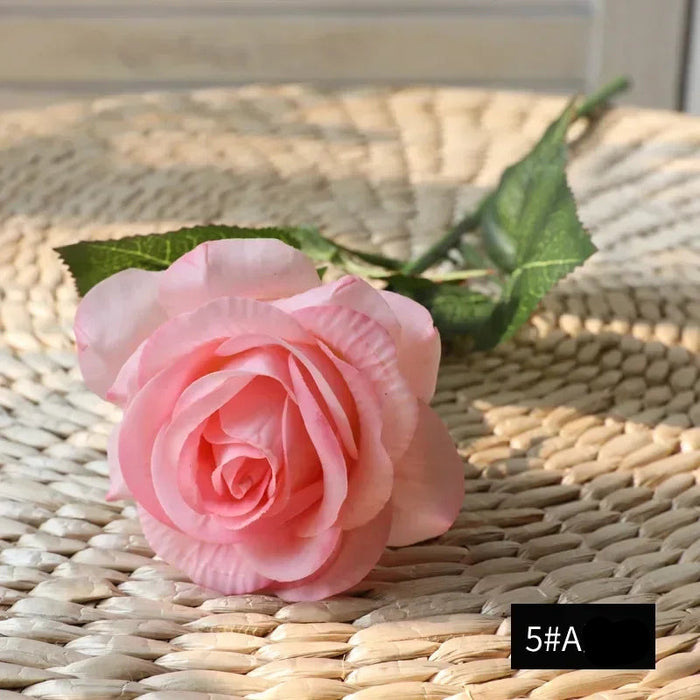 Latex real-touch artificial rose in soft pink color, showcasing realistic details and lifelike appearance.