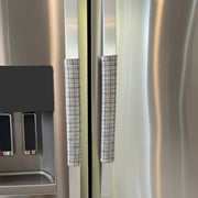 Stainless steel refrigerator with grey plaid handle covers
