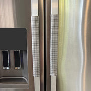 Stainless steel refrigerator with light grey plaid handle covers
