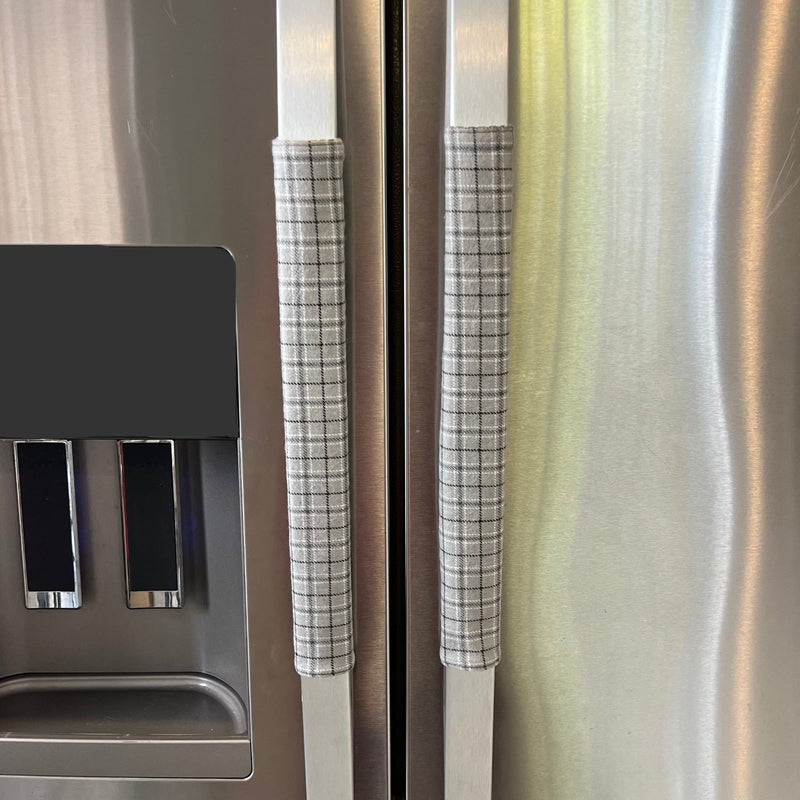 Stainless steel refrigerator with light grey plaid handle covers