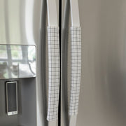 Stainless steel fridge with light grey handle covers