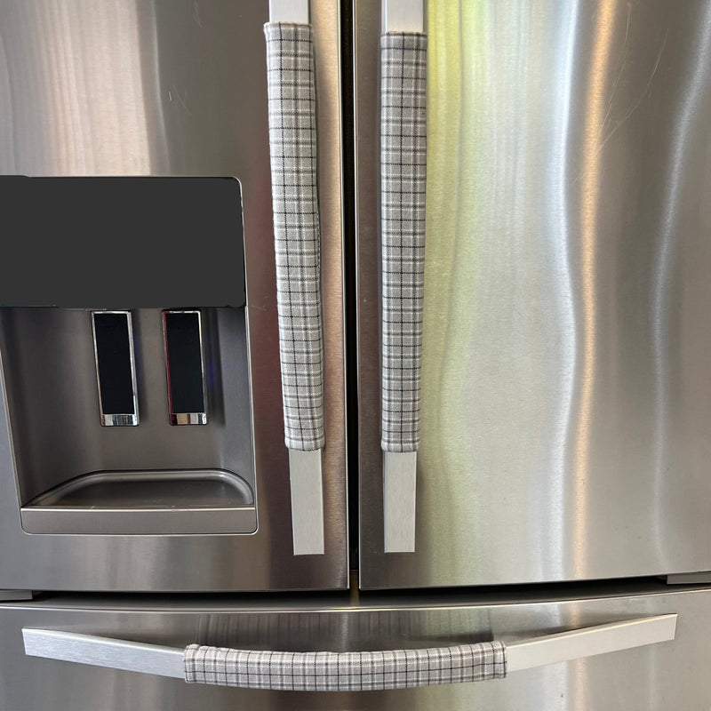 Stainless steel refrigerator with light grey plaid handle covers