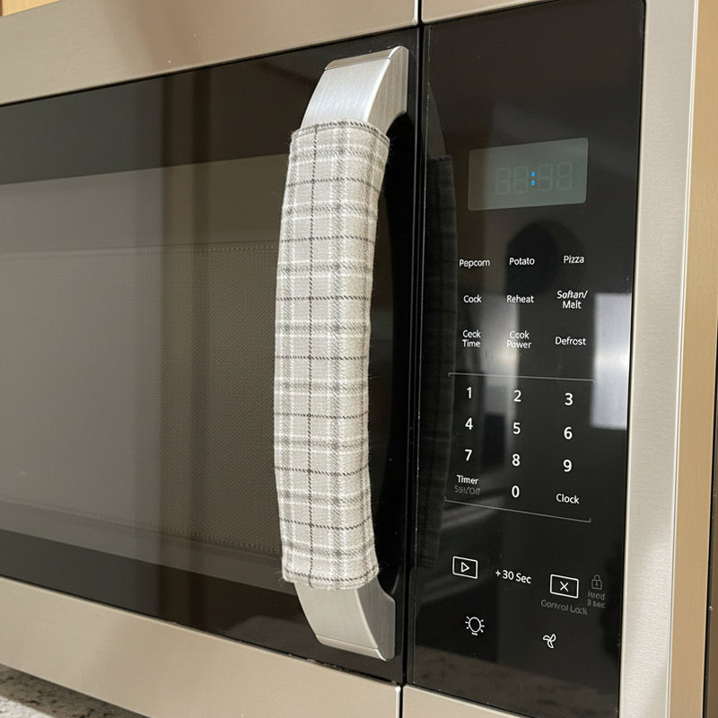 Close-up of a microwave oven with a textured handle cover