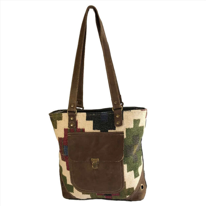 Multi color canvas tote bag with leather pocket for stylish and eco-friendly fashion.