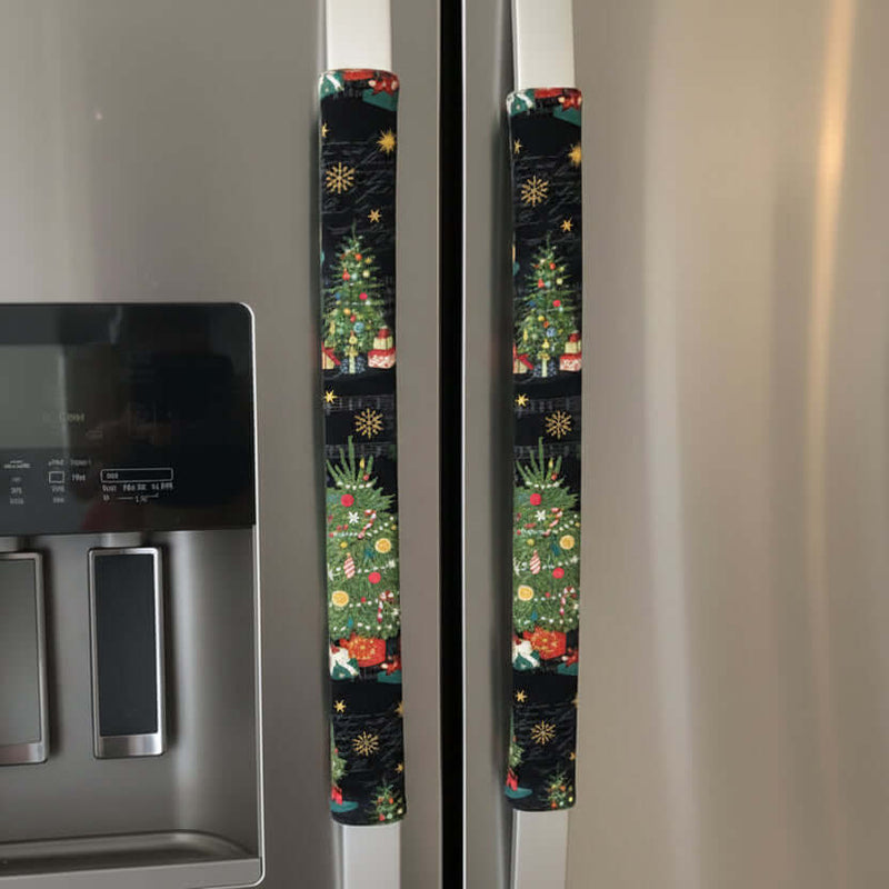 Fridge handle with a Christmas-themed cover featuring trees, stars, and Santa Claus.